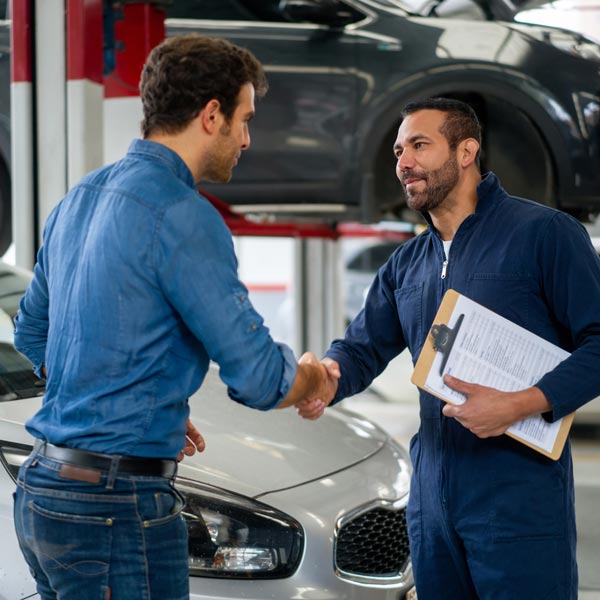 mechanic shaking hands with customer